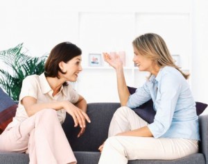 Two women talking in living room